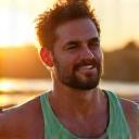 An active man in his late 30s, mid-run, showing strength and improved fitness.