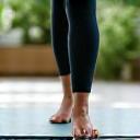 Person stretching or engaging in a moderate exercise, reflecting age-appropriate fitness