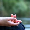 Person meditating or practicing mindfulness in a peaceful setting, representing stress management